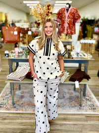 Dot to Dot Lounge Set - chic cream-and-black polka dot two-piece set featuring a sporty half-zip top, striped trim, and matching wide-leg pants.