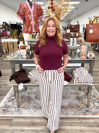 The portside pant - Cream cropped pants with thin burgundy stripes, a high-rise fit, and oversized button-detail front pockets