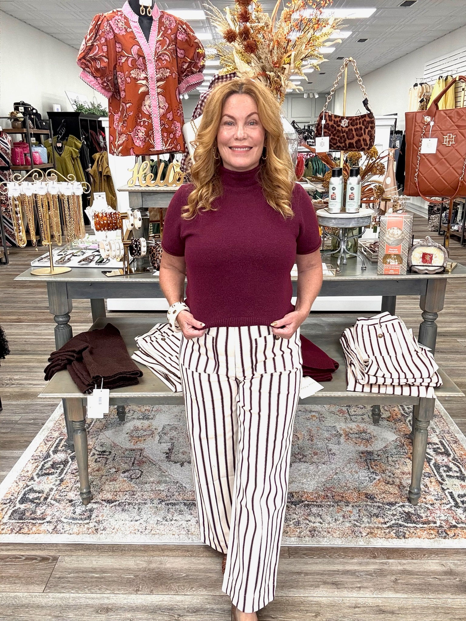 The portside pant - Cream cropped pants with thin burgundy stripes, a high-rise fit, and oversized button-detail front pockets