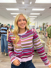Violet skies cardigan - A lightweight knit cardigan featuring a colorful striped pattern, a classic crew neckline, and a button-front design with a soft, fitted silhouette.