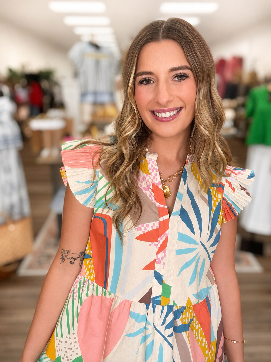 The Lily dress - A vibrant tiered mini dress with flutter sleeves, a ruffled neckline, and a colorful tropical-inspired print for a fun and effortless statement.